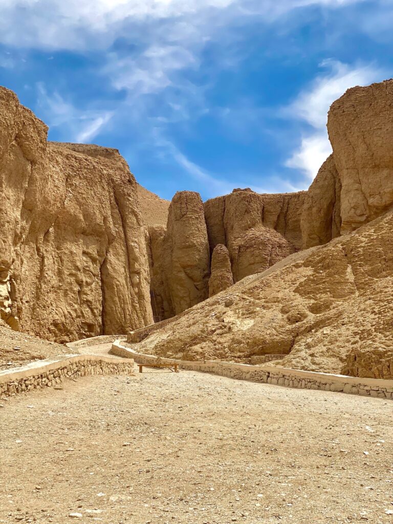 view of the mountains of the valley of the kings in egypt with a blue sky 