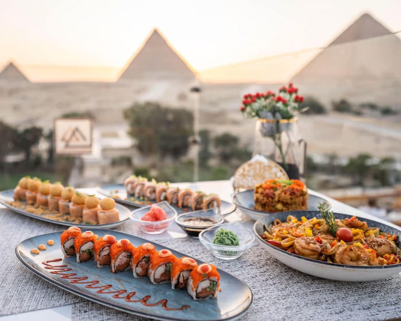 Restaurant dinner with food and a view of the Pyramids of Giza at sunset in Cairo Egypt